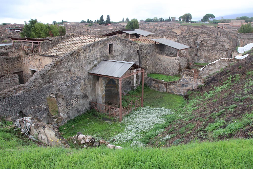 IX.7.19 Pompeii. October 2024. 
Looking north-west from rear of Casina dell’Aquila towards a wall emerging from the unexcavated on south side of area 8, on left. Photo courtesy of Klaus Heese.
