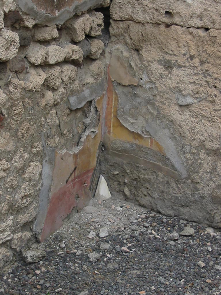 IX.7.22 Pompeii. May 2003.  
Remains of painted plaster in the room on east side of caupona. Photo courtesy of Nicolas Monteix.
