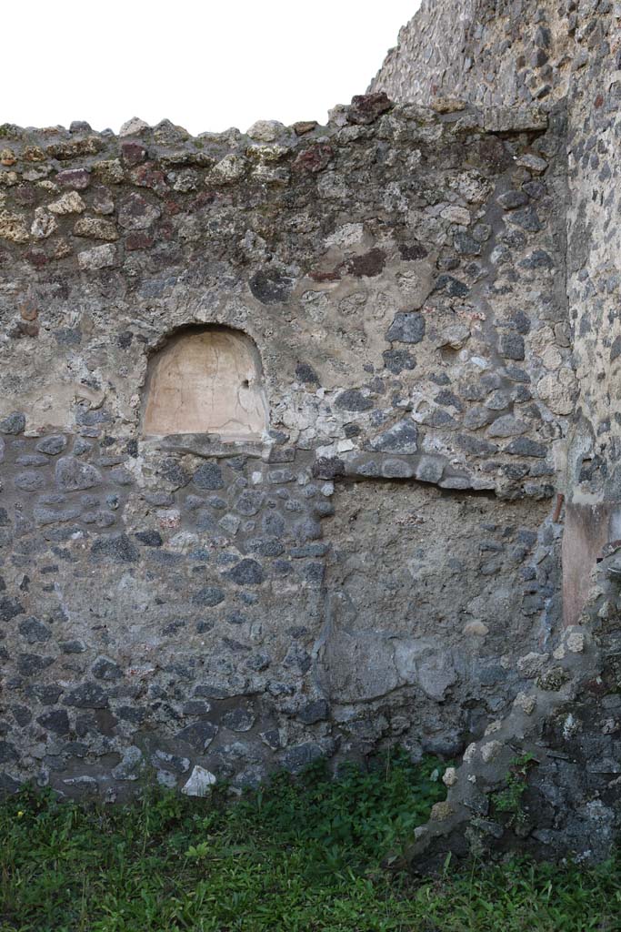 IX.8.1 Pompeii. December 2018. 
Niche at west end of south wall in shop, and area of latrine, on right. Photo courtesy of Aude Durand.
