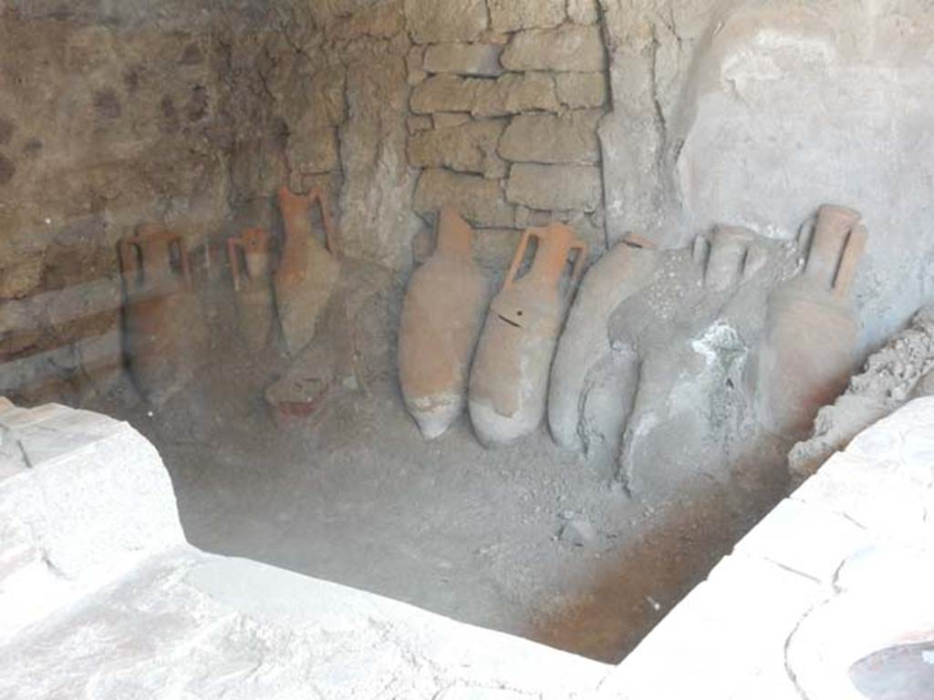 IX.11.2 Pompeii. May 2016. Looking towards amphorae leaning against east wall. 
Photo courtesy of Buzz Ferebee.
