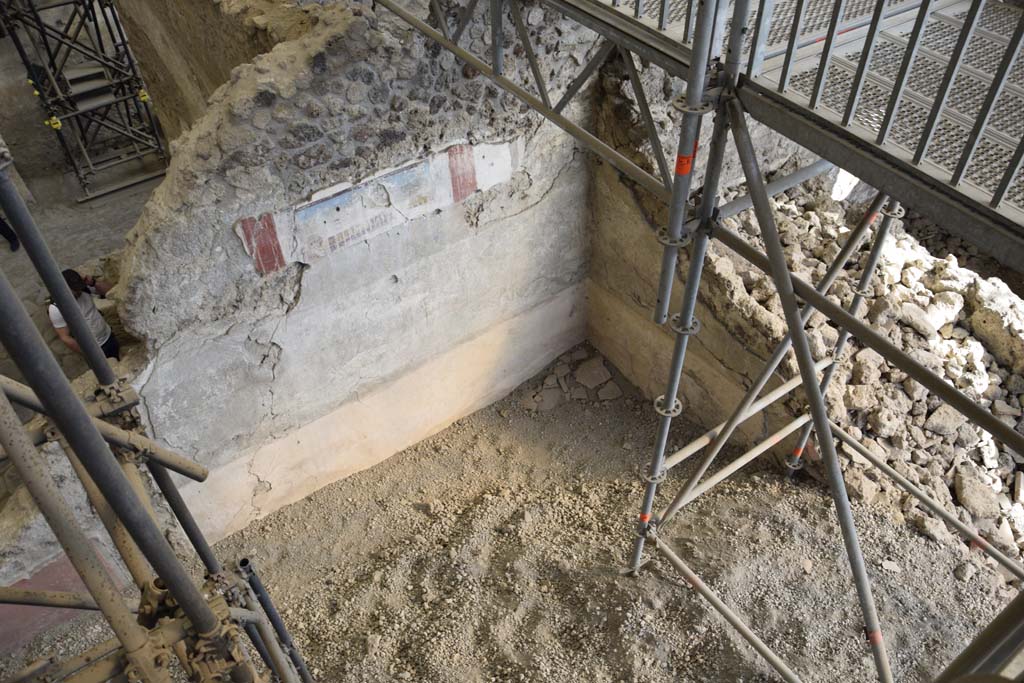 IX.12.4 Pompeii. February 2017. Room “f”. Photo courtesy of Johannes Eber.
Looking towards south-east corner of room being excavated, on west side of bakery at IX.12.6. 
On the right side of the above photo, corridor/small room “g”, can be seen.
According to Spinazzola –
“The west and east walls (of the atrium “c”) were continuous, other than for a doorway in the east wall opening in the north-east corner (into room “g”).
Here was the wooden stairway rising to the upper floor, no less than 6.50m long by a height of 5m, roughly.”
 See Spinazzola, V. Pompei, alla luce degli Scavi Nuovi di Via dell’Abbondanza (Anni 1910-1923), Vol.2, p.715-6.


