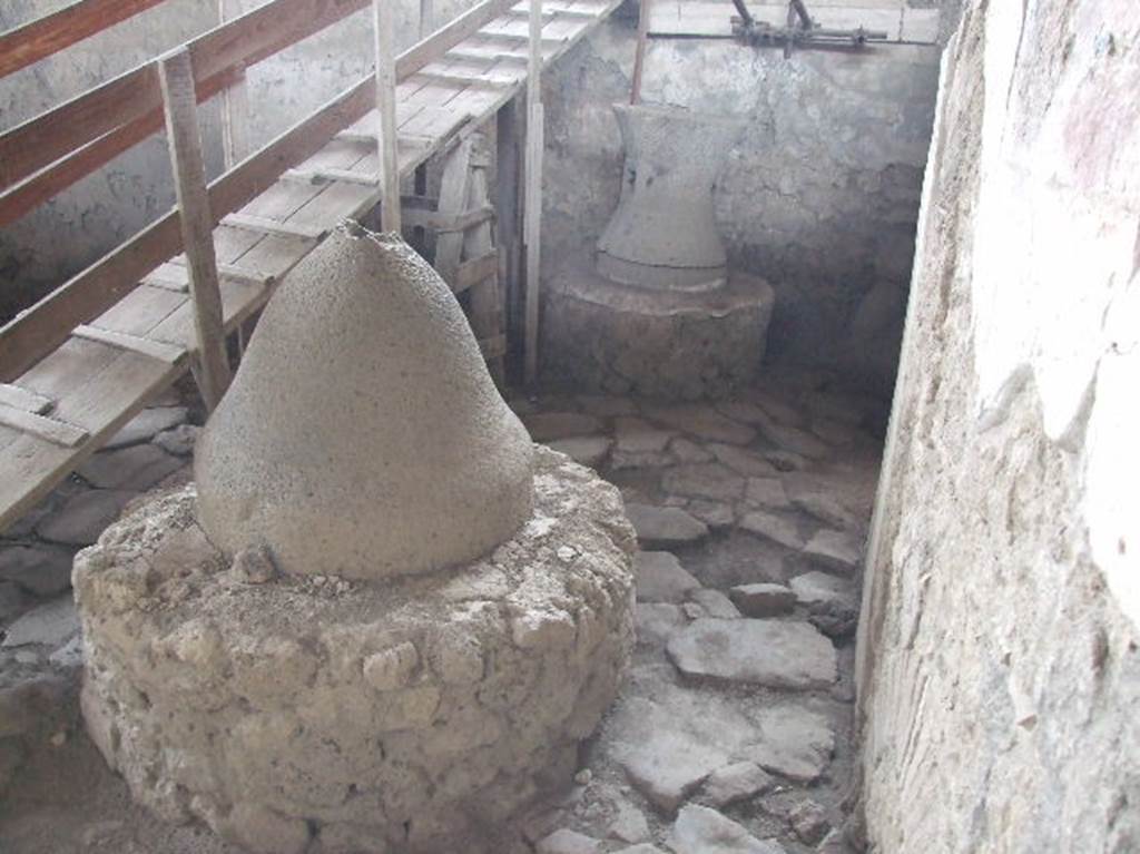 IX.12.6 Pompeii. December 2006. Room “f”, mill and grindstone. 
In 2006, the temporary steps descended from above the unexcavated area of IX.12.4 into room “f”.
