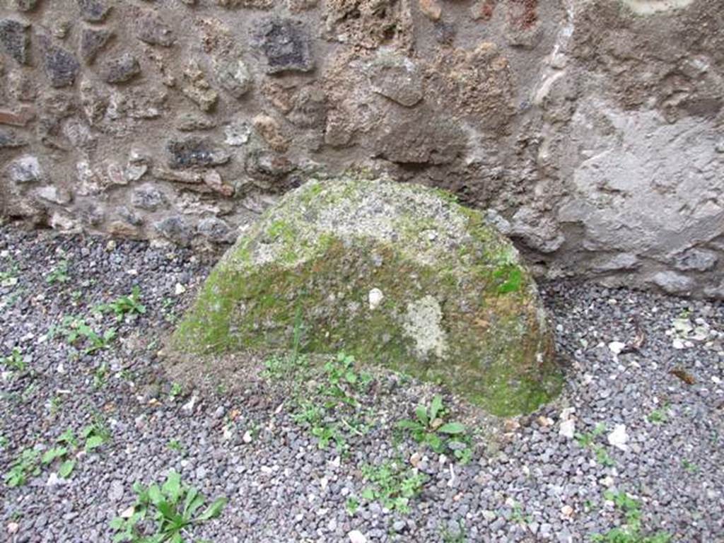 IX.14.4 Pompeii. December 2007. Round stone object in corridor (r), against west wall.