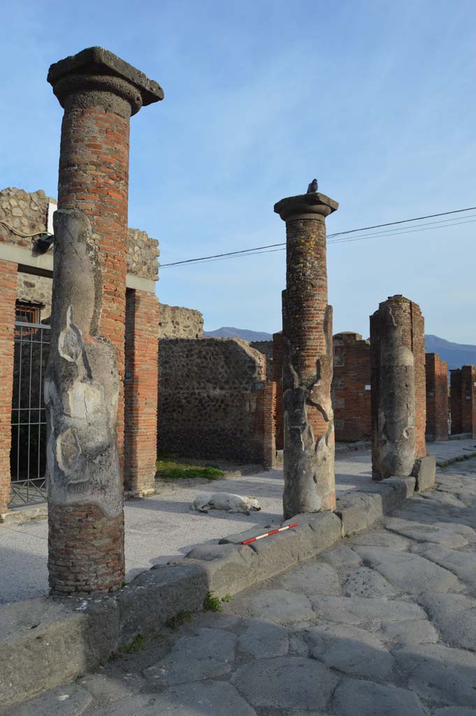 Via del Foro, east side, Pompeii. March 2019. 
Looking south-east towards third and second column from south end with pilaster/column at south end, on right, outside VII.4.12. 
Foto Taylor Lauritsen, ERC Grant 681269 DCOR.
