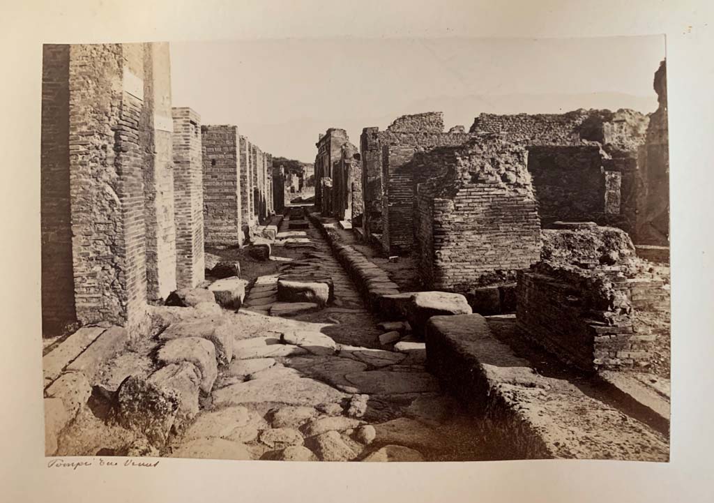 Vicolo di Eumachia, Pompeii, described as Rue? Venus. 
From an Album by M. Amodio, c.1880, entitled “Pompei, destroyed on 23 November 79, discovered in 1748”.
Looking south from junction with Vicolo del Balcone Pensile, (centre left and right). Photo courtesy of Rick Bauer.

