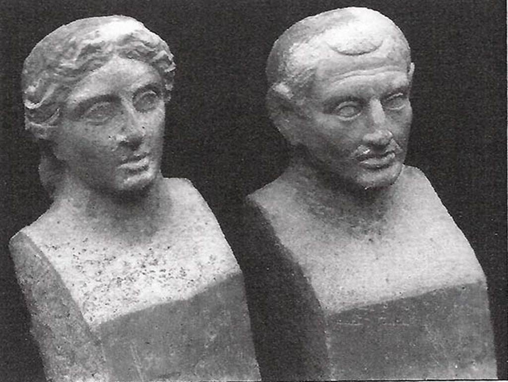 Pompeii, Villa rustica nel Fondo di Antonio Prisco. Tomb “D”.
Two travertine portraits busts found in a semi-circular niche on the west side of the tomb.

If the funeral title tablet had been recovered, we would have known who was portrayed in the two travertine busts, found in a special semi-circular niche 0.90m high; opened just below the mentioned marble slab. The two interesting portraits depict certainly the resemblance of the couple who provided for the erection of the monument; but, having to be exposed rather high up, the busts were not finished but here and there they were only sketched: the trunks were shaped as herms: 0.73m high.

In the east wall, 1.50 m above the ground, was the door, monolithic, of Vesuvian stone, mounted between threshold, architrave and door-jambs equally monolithic and of the same stone, 0.80 m high. The door-jambs being slightly inclined at the top, the door, which opened from the outside in, appeared pyramidal externally. 

The interior of the tomb, a columbarium (a place for the respectful storage of cinerary urns) all covered with white stucco, consisted of two floors, the higher at the height of the threshold of the door, the lower, about 2 m underneath the first, and accessible by a central hatch of 0.70 m at the side.  

In the upper floor, in each corner was embedded a terracotta pot over a small masonry pedestal; at the same level a channel was open along the walls; in the western wall two circular openings, opened above the mentioned channel, communicating with the exterior; in the opposite eastern and western walls are two semi-circular niches, 0.60 m high. 

The lower floor was a columbarium of thirty-two niches, presenting eight semi-circular niches on each wall, arranged in two superimposed orders. Of the pots, and the remains they held, only a few fragments were found, because the columbarium had already been disturbed a long time ago, from searchers who penetrated from the tholos, which was probably not fully covered over by the 79AD eruption, demolishing the solid masonry.

See Stefani G., 1998. Pompei oltre la vita: Nuove testimonianze dalle necropoli, p. 106-8.
See Della Corte M., Notizie degli Scavi di Antichità, 1921, p. 416, fig. 4.

