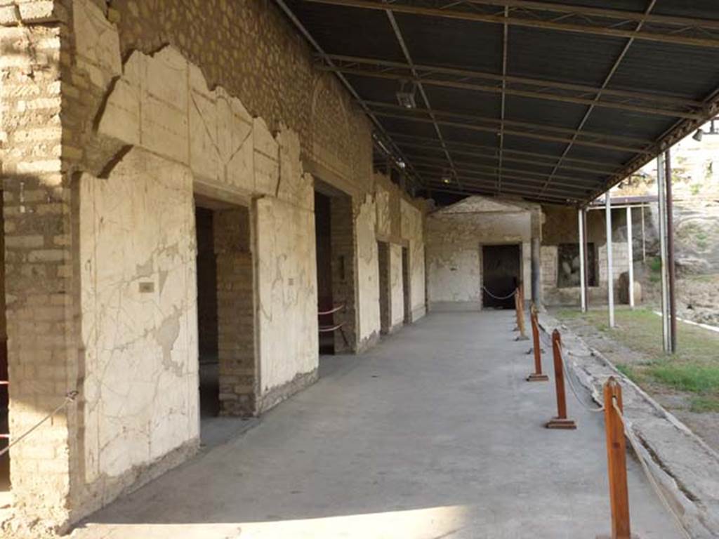 Oplontis, September 2011. Portico 60, looking north along the portico on the west side of the swimming pool. On the left are two doors of room 72, followed by room 74, 88, and 89 in the west wall. At the far end is the doorway of a room in the north wall. Photo courtesy of Michael Binns.
