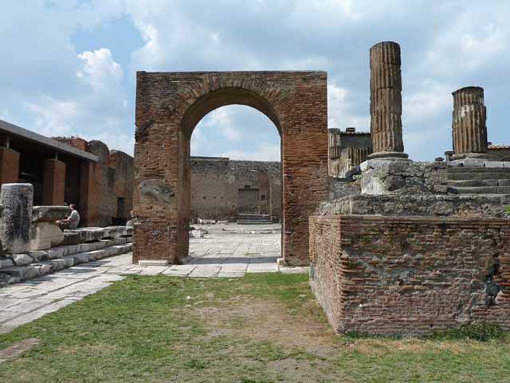 Arch of Augustus. May 2010. Looking north along the west side of the Temple of Jupiter.