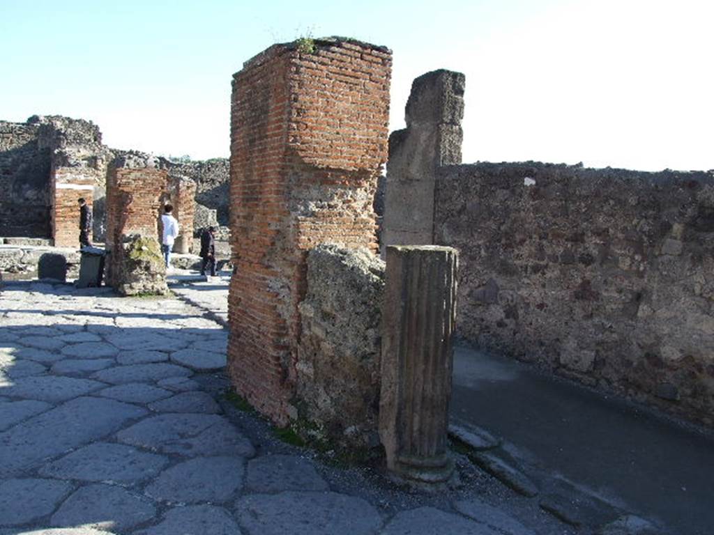 Arch of Marcus Holconius Rufus. December 2006. South west pillar with remains of a statue base and a column. One of the four pillars supporting the arch.